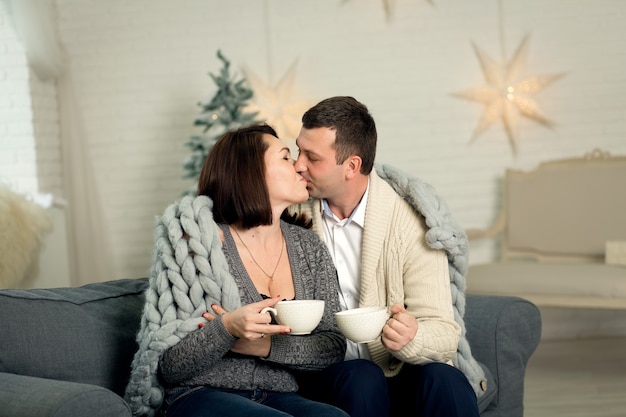 Young couple in love spend Christmas night together enjoying each other.