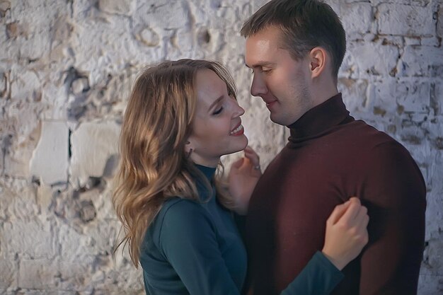 young couple in love in studio / boy and girl are hugging in the interior of a cozy home