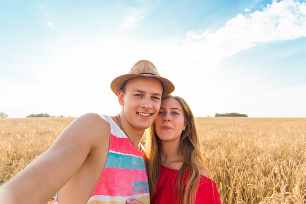 Young couple in love taking selfie outdoors