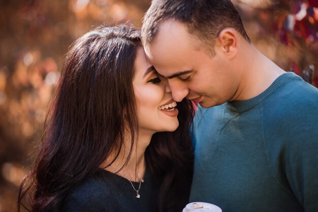 young couple in love walking in the autumn forest