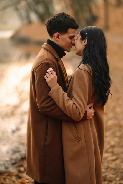 Young couple in love walking in the park on a autumn day Enjoying time together