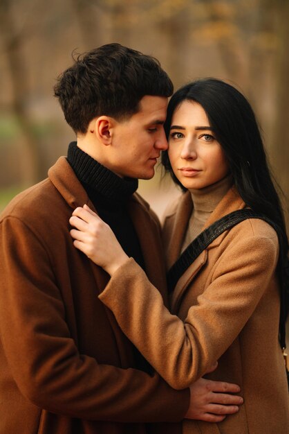 Young couple in love walking in the park on a autumn day Enjoying time together