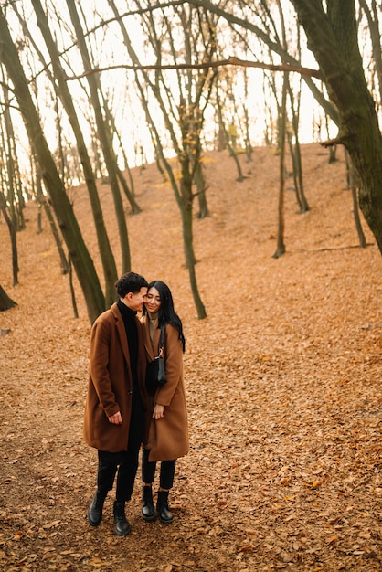 Young couple in love walking in the park on an autumn day