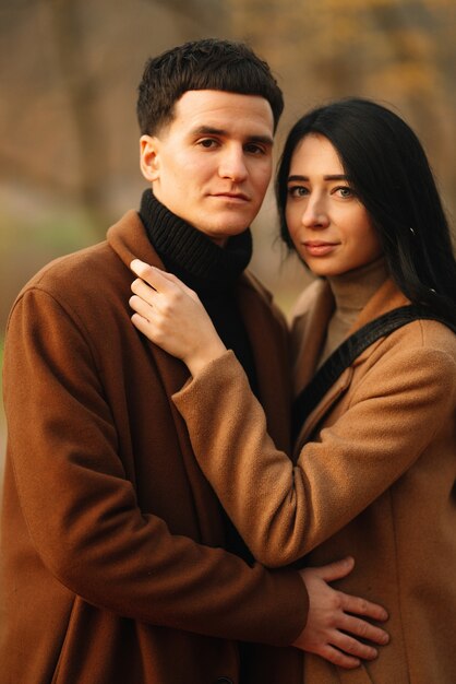 Young couple in love walking in the park on an autumn day