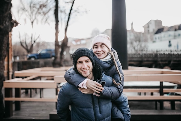 young couple in love in winter clothes walking around the city on a date