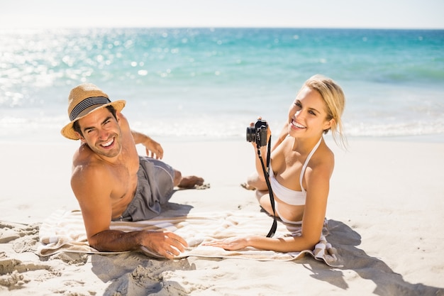 Young couple lying on beach