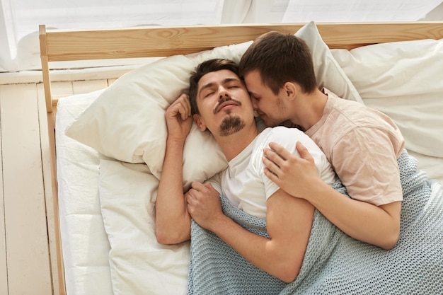 Young couple lying on bed at home