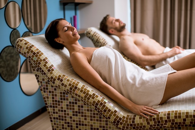 Young couple lying on the tepidarium beds