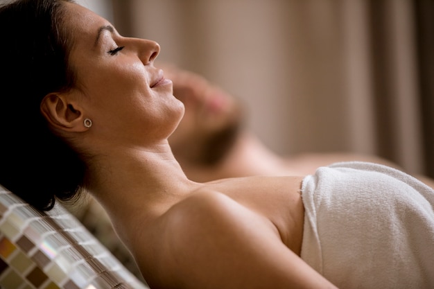 Young couple lying on the tepidarium beds