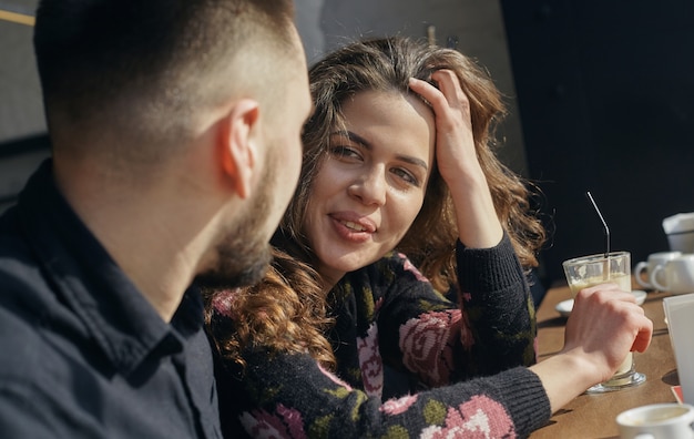 Young couple - man and woman - drinking coffee in a cafe