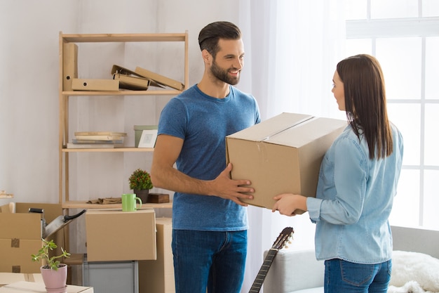 Young couple man and woman moving to a new apartment together relocation