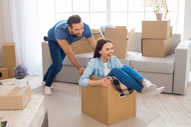 Young couple man and woman moving to a new apartment together relocation