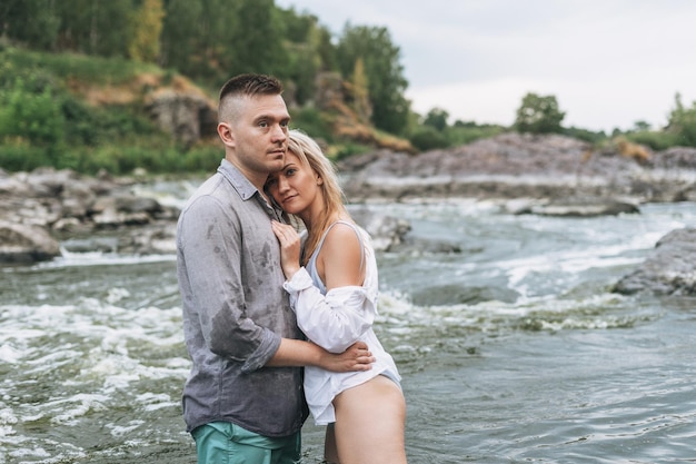 Young couple in mountains river