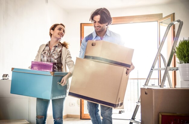 Young couple moving in into new apartment