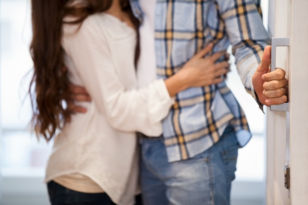 Young couple opening the door