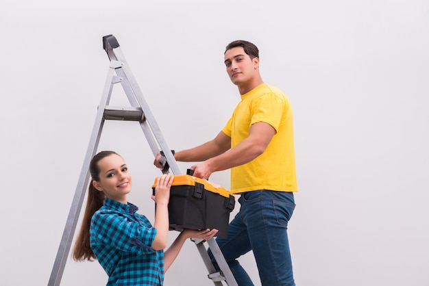 Young couple painting wall at home