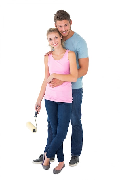 Young couple painting with roller