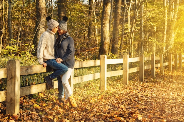 Young couple in the park at sunny autumn day