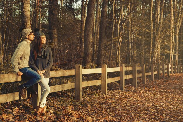 Young couple in the park at sunny autumn day