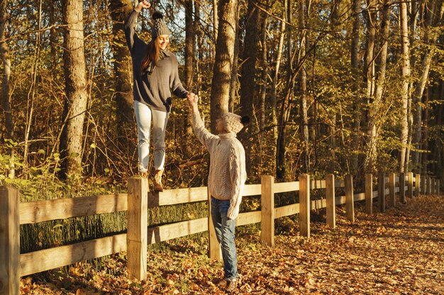 Young couple in the park at sunny autumn day