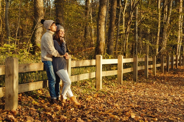 Young couple in the park at sunny autumn day