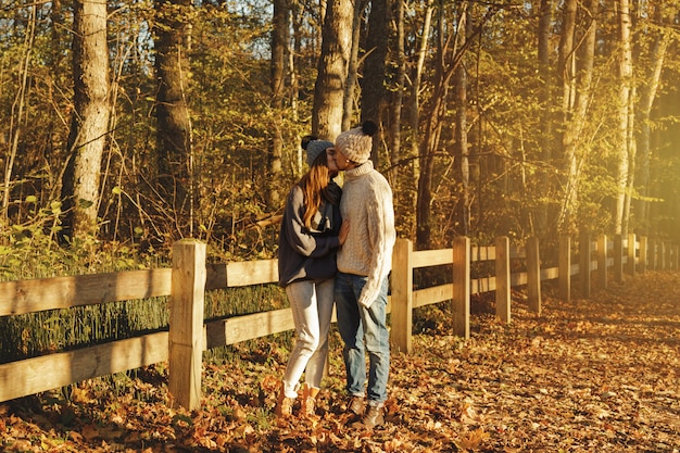 Young couple in the park at sunny autumn day