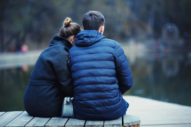 young couple at the park in winter view from the back