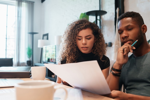 Young couple planning monthly budget together.