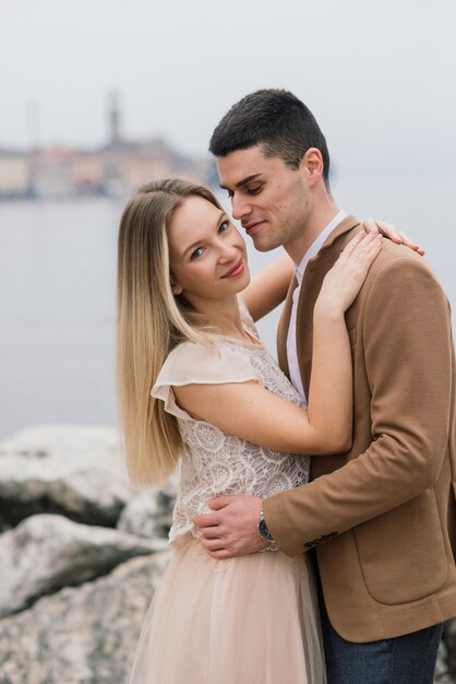 Young couple posing on the river dock