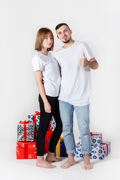 Young couple posing with christmas gifts