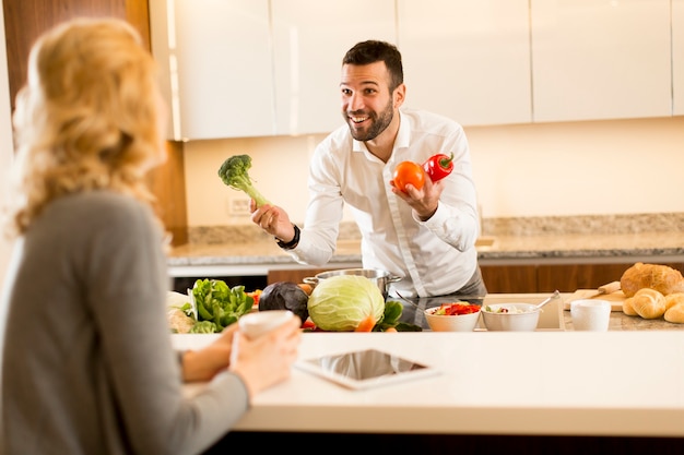 Young couple preparing meal in the modern kitchen