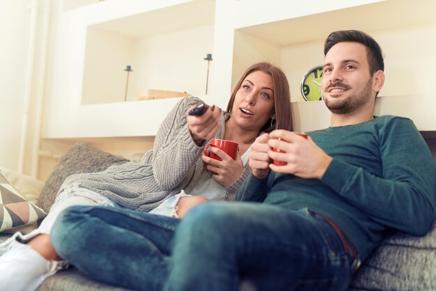 Young couple preparing to watch a movie