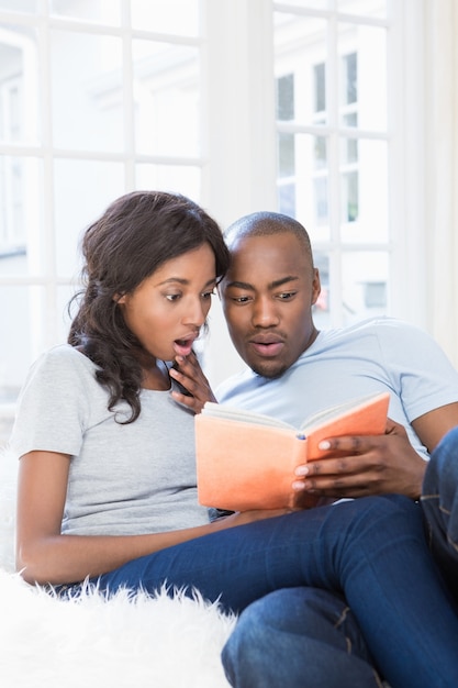 Young couple reading book