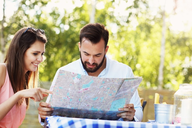 A young couple reading map in cafe