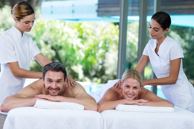 Young couple receiving a back massage from masseur