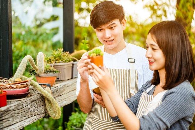 Young couple relax in the garden at homeThey care plant and flowerNature Hobby Interior and Lover Concept