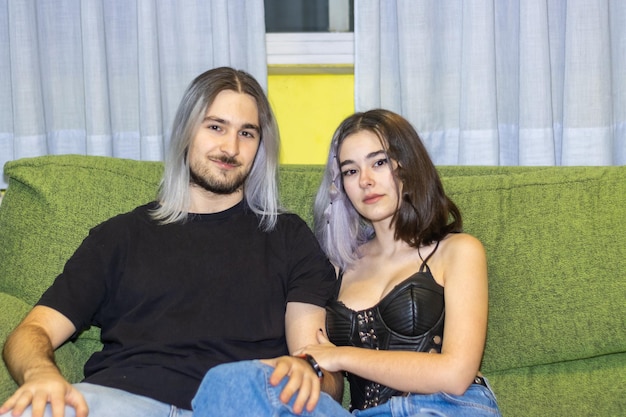 Young couple relaxing on a comfortable green sofa