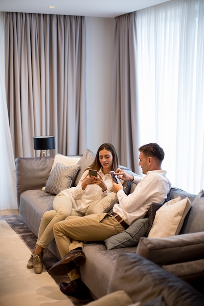 Young couple relaxing on couch in luxury living room