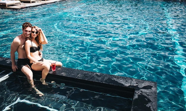 Young couple resting at swimming pool