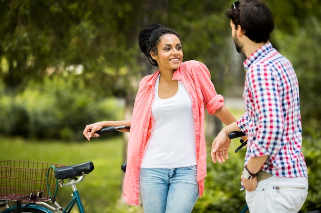 Young couple riding on the tandem bicycle