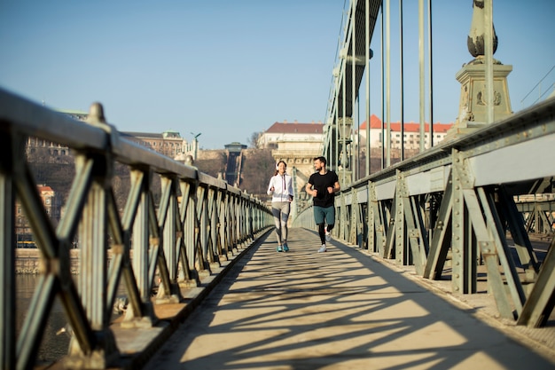 Young couple running in urban enviroment