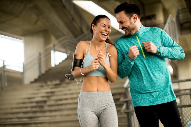 Young couple running in urban enviroment