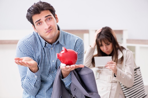 Young couple saving money for new furniture