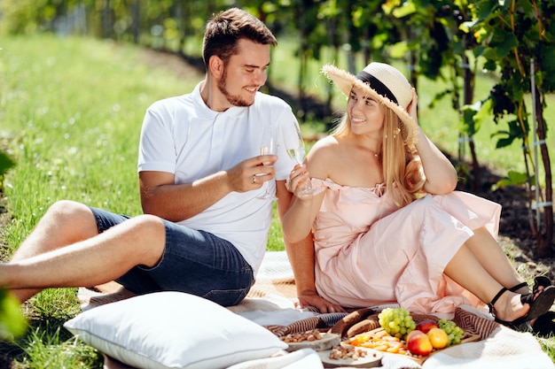 A young couple shares a happy moment picnicking on the grass in the countryside