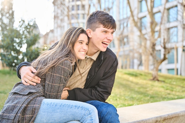 Young couple sharing laughter and joy sitting on the street in unforgettable moments