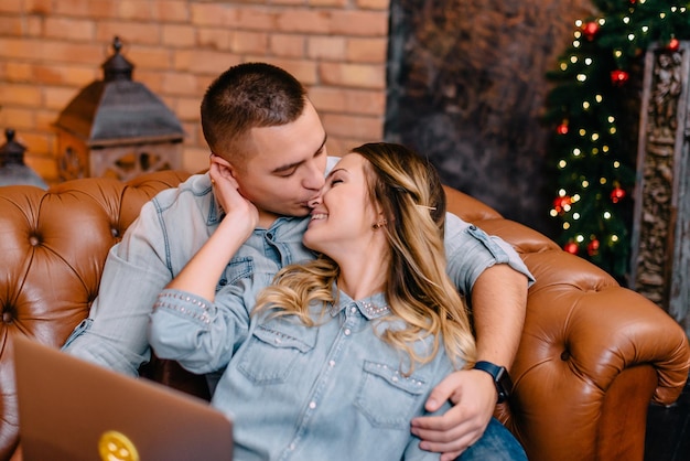 Young couple shopping online at home on Christmas Eve