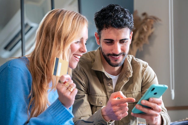 young couple shopping online with credit card and mobile phone