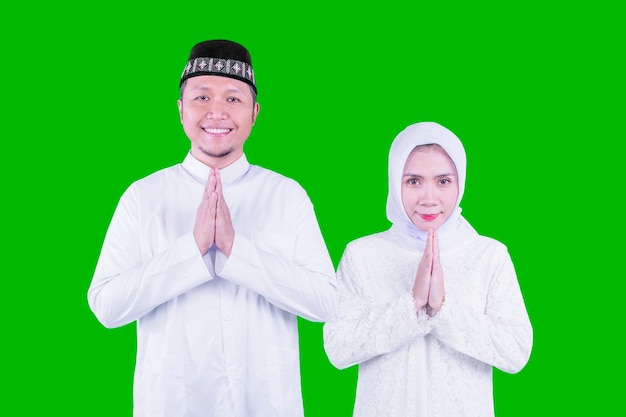 Young couple show congratulate gesture Eid Mubarak