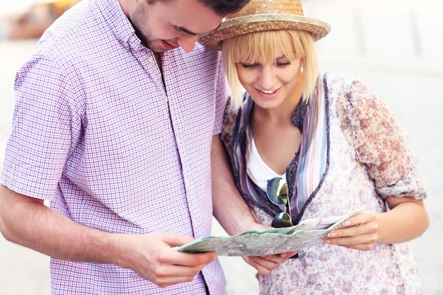 young couple sightseeing with a map