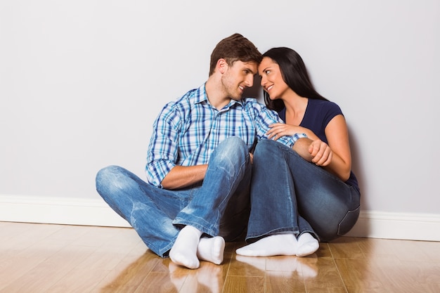 Young couple sitting on floor 